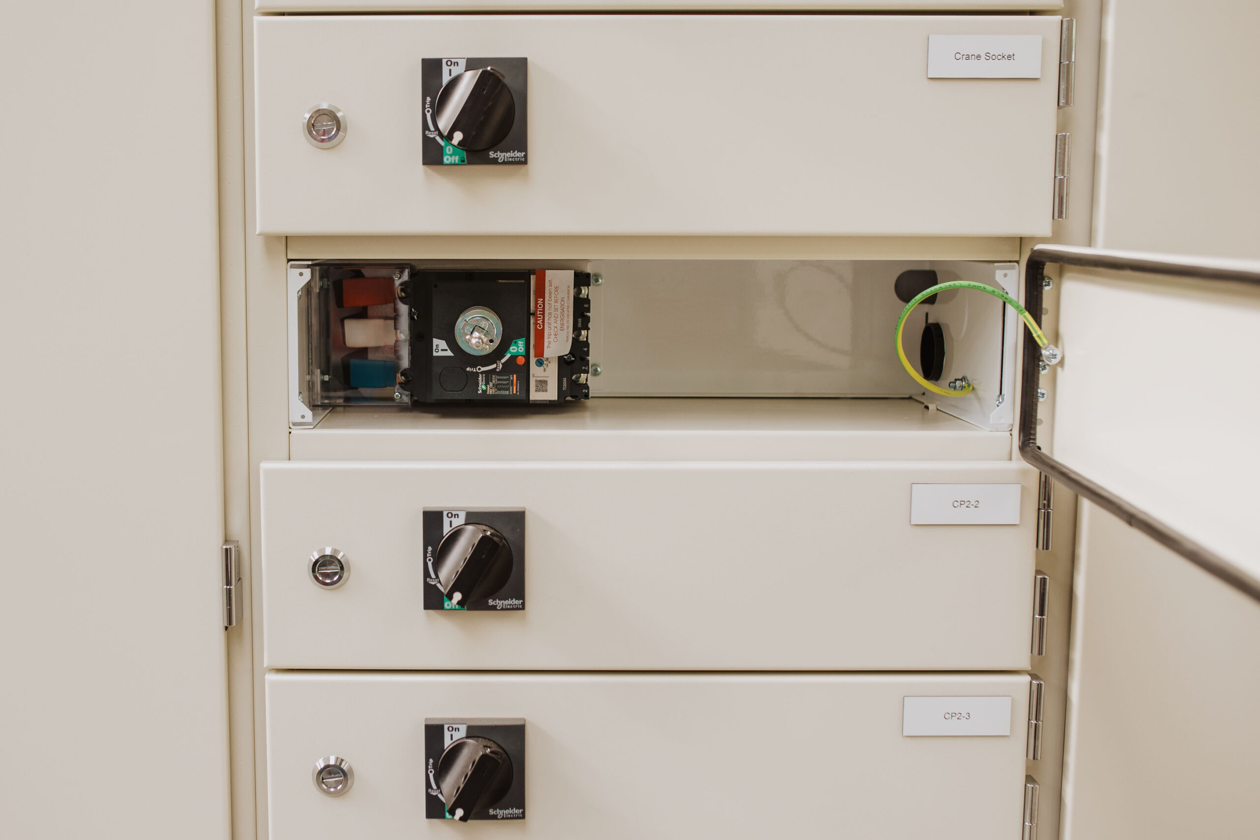 Motor control centre drawer compartments with Schneider Electric switches and crane socket labelling by Clive Wilson Switchboards