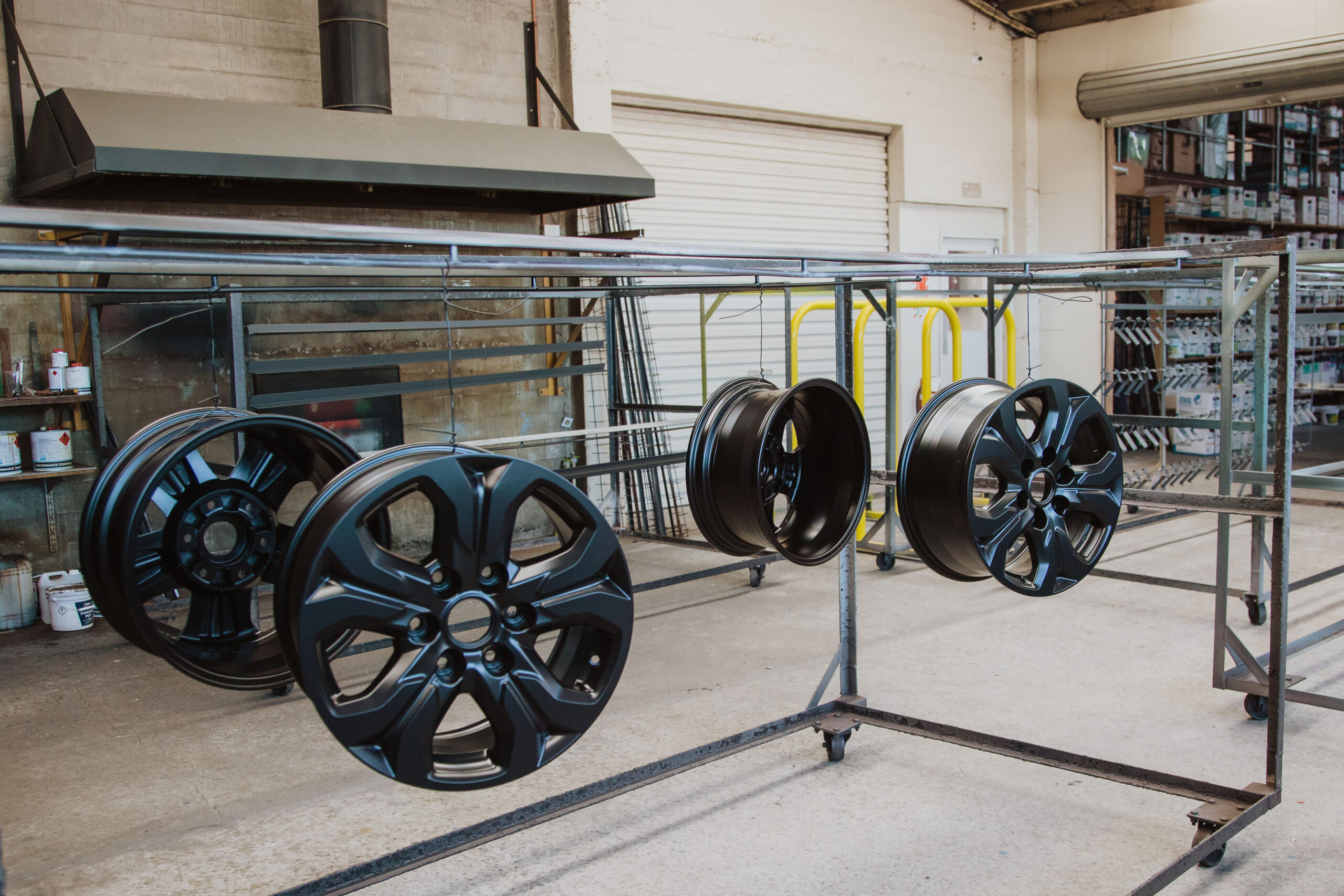 Powder coated wheels hanging in the CWS workshop