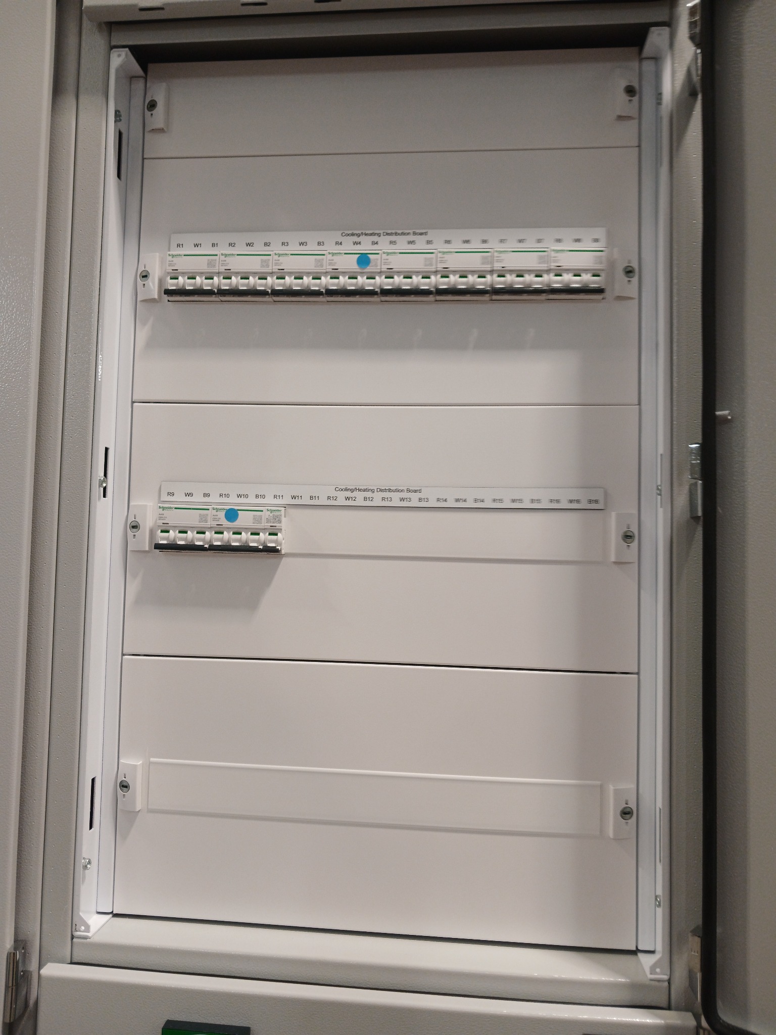 Cooling and heating distribution board with circuit labels and front plates fitted